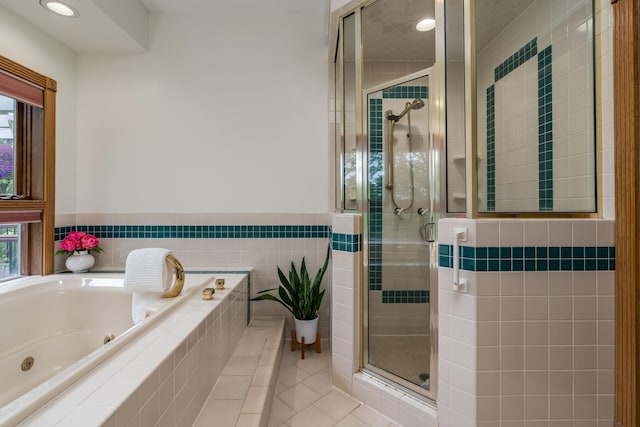 17 Oriole Pl, North Mankato, MN 56003 - full bath featuring a stall shower, a tub with jets, tile patterned flooring, plenty of natural light, and tile walls
