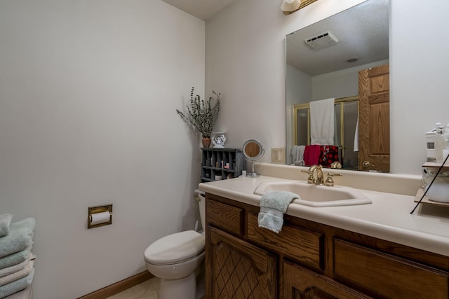 17 Oriole Pl, North Mankato, MN 56003 - full bathroom featuring toilet, vanity, a stall shower, and baseboards