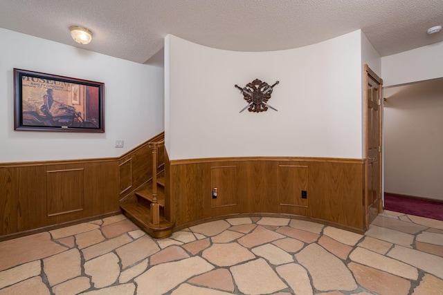 17 Oriole Pl, North Mankato, MN 56003 - empty room with a textured ceiling, wainscoting, and wood walls