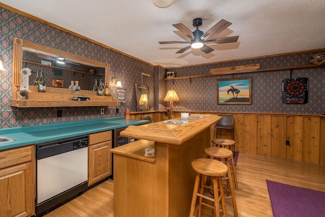 17 Oriole Pl, North Mankato, MN 56003 - indoor dry bar featuring dishwasher, light wood-style floors, wallpapered walls, crown molding, and wainscoting
