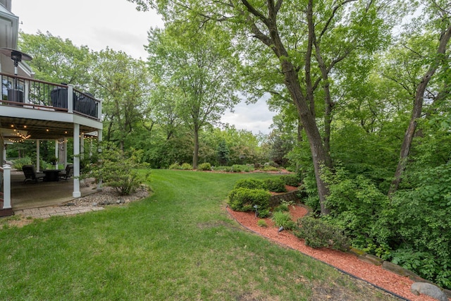 17 Oriole Pl, North Mankato, MN 56003 - view of green lawn featuring a patio area and a wooden deck