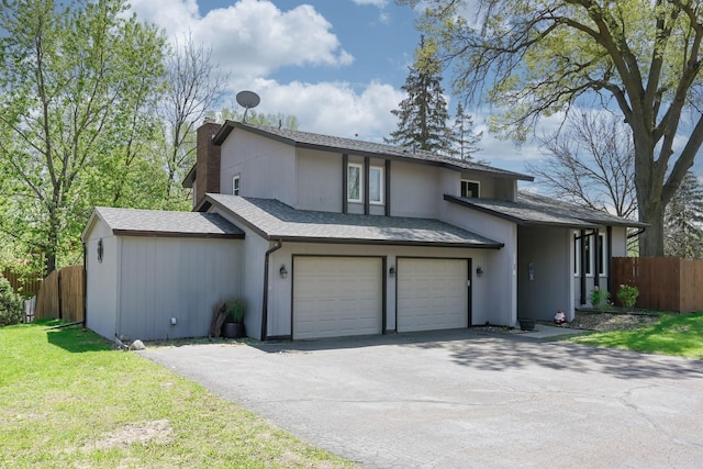 1158 Rockstone Ln, New Brighton, MN 55112 - view of front of home featuring asphalt driveway, a chimney, a garage, and roof with shingles