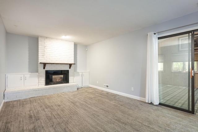 1158 Rockstone Ln, New Brighton, MN 55112 - unfurnished living room featuring a brick fireplace, carpet flooring, and baseboards