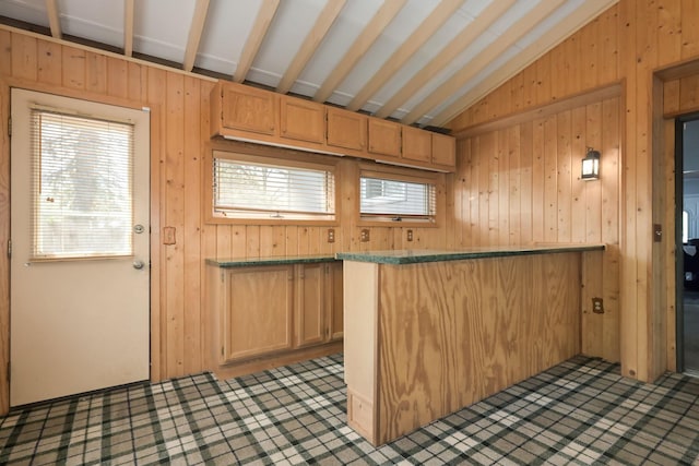 1158 Rockstone Ln, New Brighton, MN 55112 - kitchen featuring wood walls, vaulted ceiling, and a peninsula