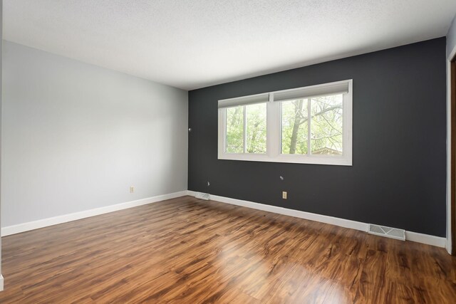1158 Rockstone Ln, New Brighton, MN 55112 - empty room featuring dark wood-style floors and baseboards