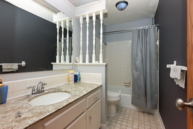 1158 Rockstone Ln, New Brighton, MN 55112 - bathroom featuring vanity, toilet, shower / bath combo with shower curtain, and baseboards