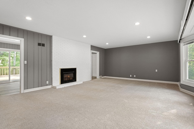 11600 Timberline Rd, Minnetonka, MN 55305 - unfurnished living room featuring light carpet, a brick fireplace, recessed lighting, and baseboards