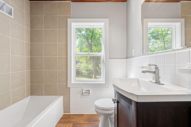 11600 Timberline Rd, Minnetonka, MN 55305 - full bathroom featuring tile walls, healthy amount of natural light, vanity, toilet, and wood finished floors