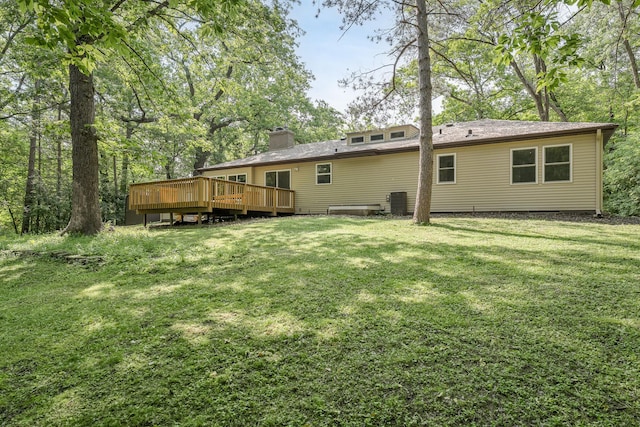 11600 Timberline Rd, Minnetonka, MN 55305 - rear view of house featuring a deck, a yard, a chimney, and central air condition unit