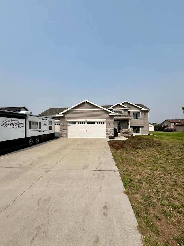 1020 7th Ave NW, Rice, MN 56367 - view of front of home featuring an attached garage, driveway, a front yard, and stone siding
