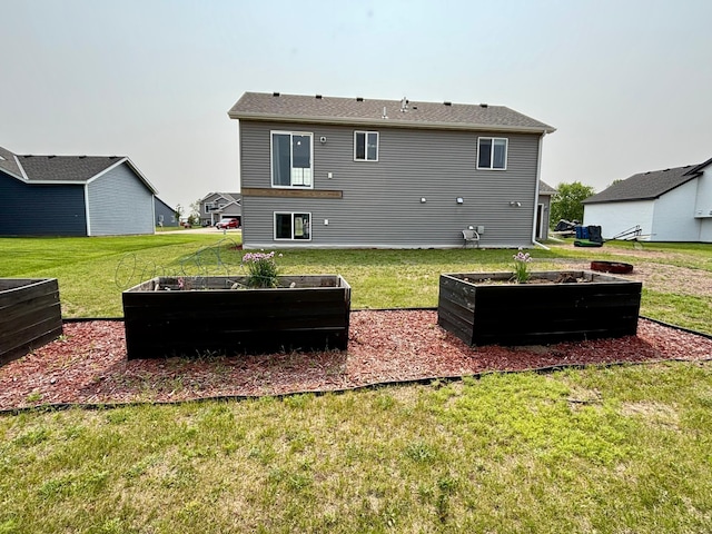 1020 7th Ave NW, Rice, MN 56367 - back of house featuring a vegetable garden and a lawn