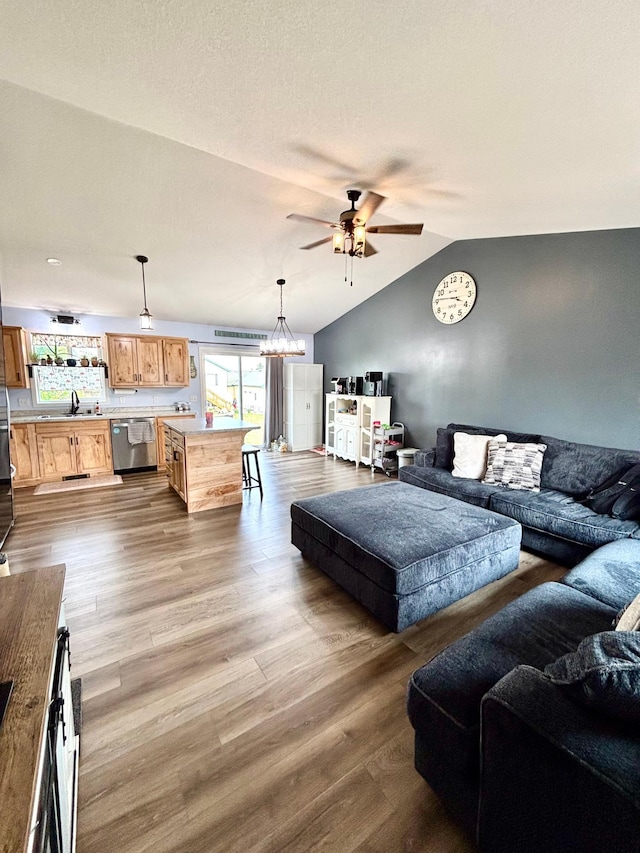 1020 7th Ave NW, Rice, MN 56367 - living area featuring ceiling fan, lofted ceiling, wood finished floors, and a chandelier