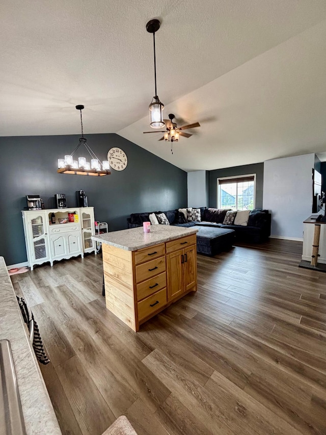 1020 7th Ave NW, Rice, MN 56367 - kitchen featuring ceiling fan, dark wood-style floors, lofted ceiling, open floor plan, and pendant lighting