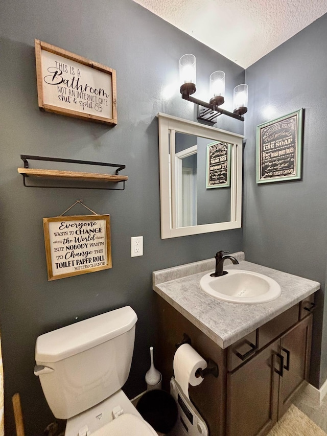 1020 7th Ave NW, Rice, MN 56367 - half bath with vanity, toilet, and a textured ceiling