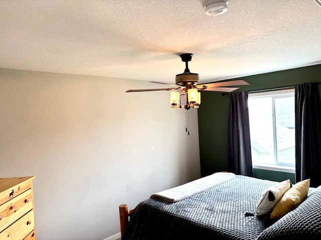 1020 7th Ave NW, Rice, MN 56367 - bedroom featuring baseboards, a textured ceiling, and ceiling fan