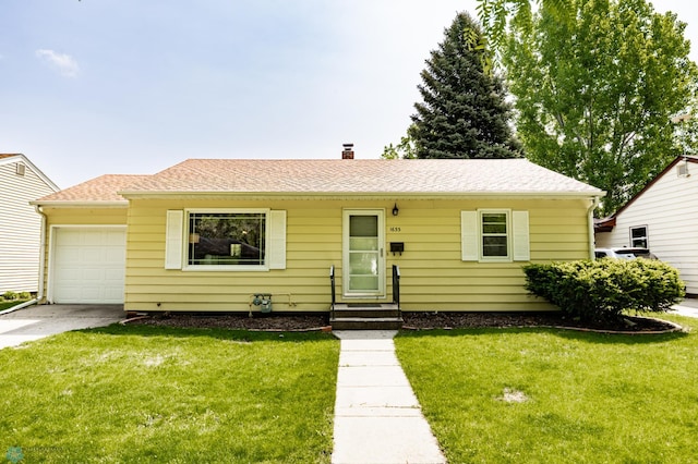1633 1st St N, Fargo, ND 58102 - view of front of home with an attached garage, driveway, and a front lawn