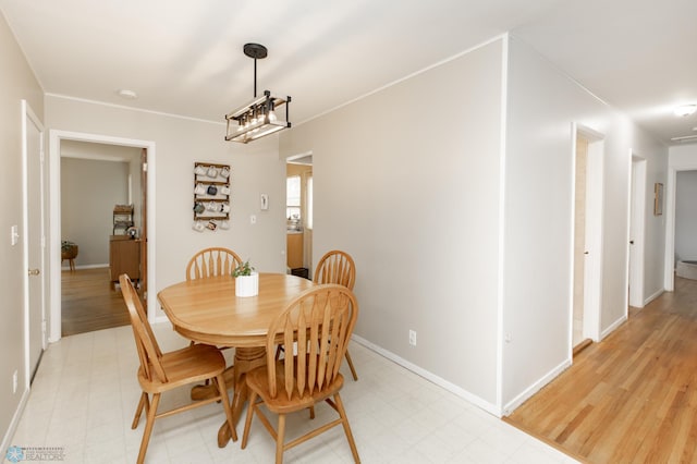 1633 1st St N, Fargo, ND 58102 - dining room featuring baseboards, light flooring, and crown molding