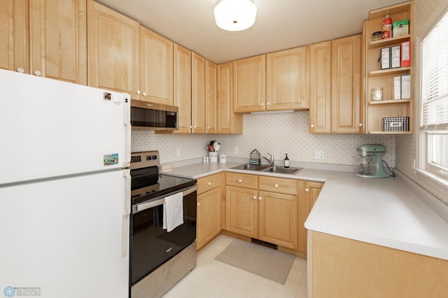 1633 1st St N, Fargo, ND 58102 - kitchen featuring stainless steel appliances, light brown cabinets, a sink, open shelves, and light countertops
