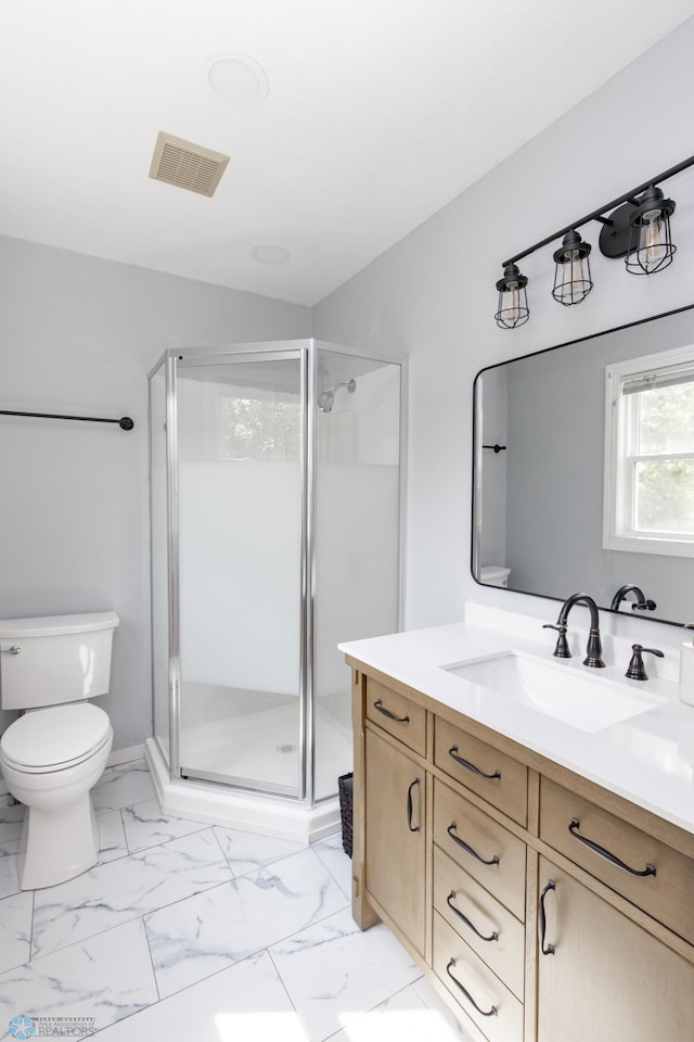 1633 1st St N, Fargo, ND 58102 - bathroom featuring vanity, a shower stall, toilet, and marble look tiles