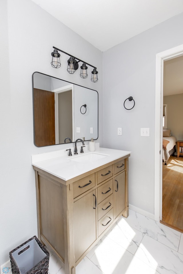 1633 1st St N, Fargo, ND 58102 - bathroom featuring vanity, marble look tiles, and baseboards