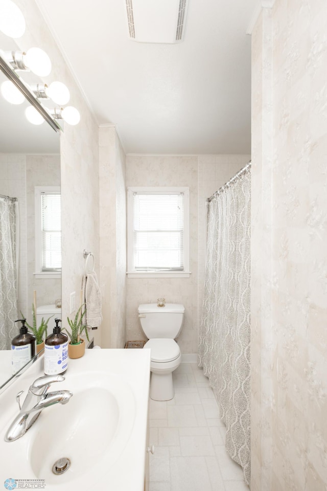 1633 1st St N, Fargo, ND 58102 - full bathroom featuring toilet, vanity, and tile patterned floors