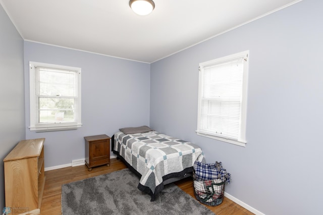 1633 1st St N, Fargo, ND 58102 - bedroom with wood finished floors, ornamental molding, and baseboards