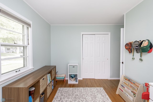 1633 1st St N, Fargo, ND 58102 - game room featuring wood finished floors, plenty of natural light, crown molding, and baseboards