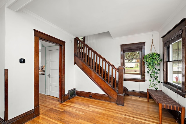 1144 Abell St, Saint Paul, MN 55117 - foyer entrance featuring light wood-style flooring, baseboards, stairway, and crown molding