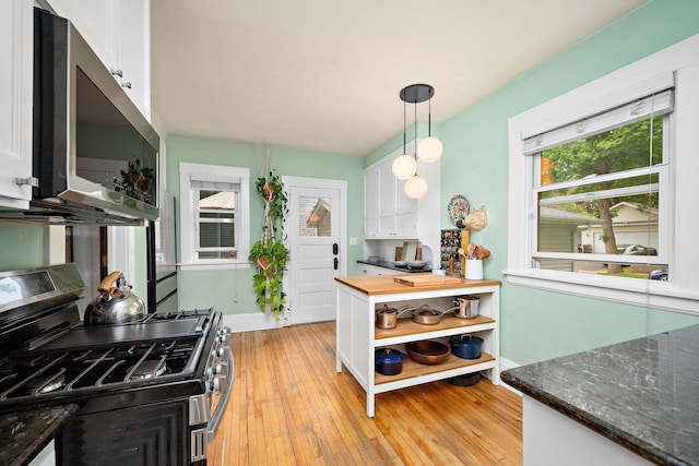 1144 Abell St, Saint Paul, MN 55117 - kitchen featuring appliances with stainless steel finishes, white cabinets, open shelves, and light wood-type flooring