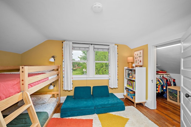 1144 Abell St, Saint Paul, MN 55117 - bedroom featuring lofted ceiling, wood finished floors, a spacious closet, baseboards, and a closet