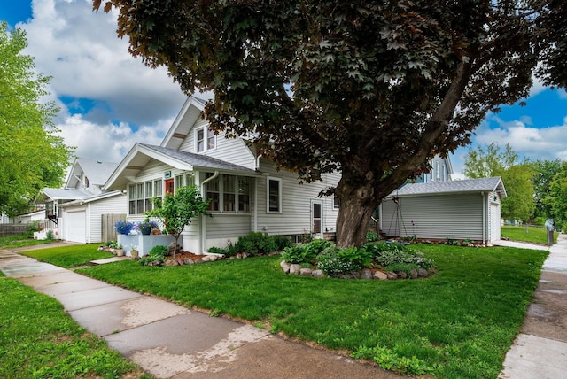 1144 Abell St, Saint Paul, MN 55117 - view of front facade featuring a garage and a front lawn