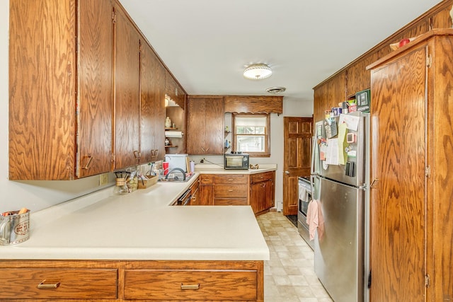 266 Janice St, Shoreview, MN 55126 - kitchen featuring appliances with stainless steel finishes, light countertops, brown cabinetry, light floors, and a sink