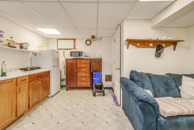 266 Janice St, Shoreview, MN 55126 - kitchen featuring freestanding refrigerator, open shelves, a paneled ceiling, light flooring, and open floor plan