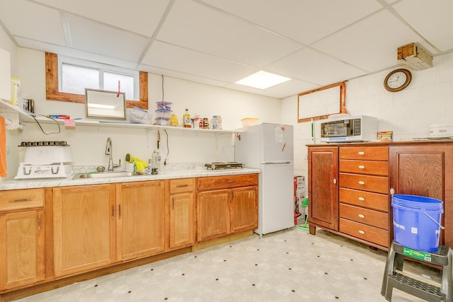 266 Janice St, Shoreview, MN 55126 - kitchen featuring freestanding refrigerator, light flooring, a sink, a paneled ceiling, and light countertops