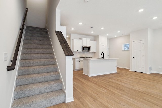 6687 Bluestem Way, Minnetrista, MN 55331 - stairway with wood finished floors, recessed lighting, and baseboards