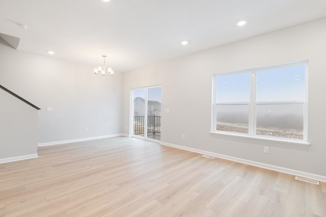 6687 Bluestem Way, Minnetrista, MN 55331 - unfurnished living room featuring a chandelier, healthy amount of natural light, baseboards, and recessed lighting