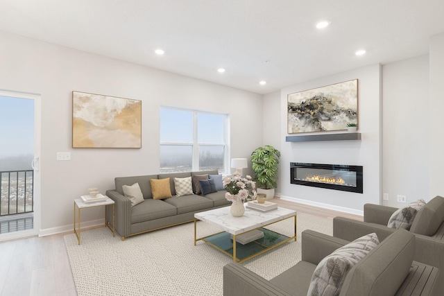 6687 Bluestem Way, Minnetrista, MN 55331 - living room featuring recessed lighting, a glass covered fireplace, light wood-style floors, and baseboards