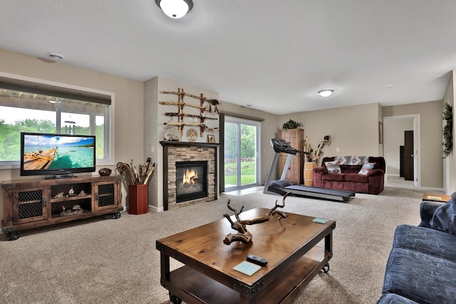 1217 Blossom Blvd NW, Isanti, MN 55040 - carpeted living room featuring a stone fireplace, baseboards, and a textured ceiling