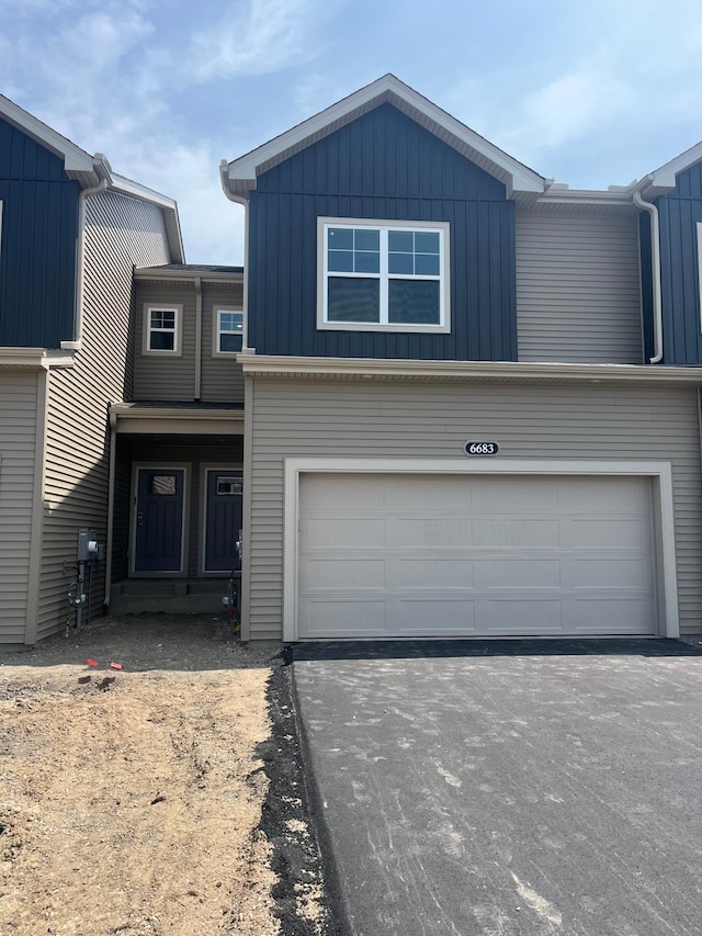 6683 Bluestem Way, Minnetrista, MN 55331 - view of front of property with driveway, board and batten siding, and a garage