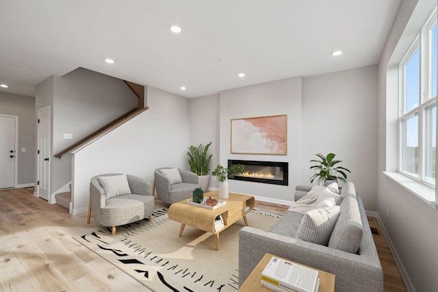 6683 Bluestem Way, Minnetrista, MN 55331 - living area featuring wood finished floors, stairs, healthy amount of natural light, and recessed lighting