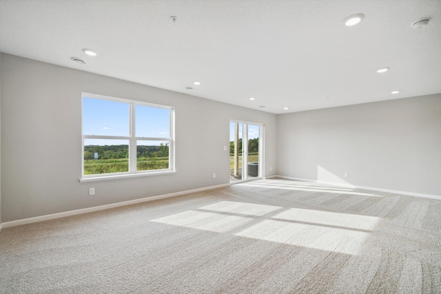 6683 Bluestem Way, Minnetrista, MN 55331 - empty room featuring light carpet, baseboards, and recessed lighting