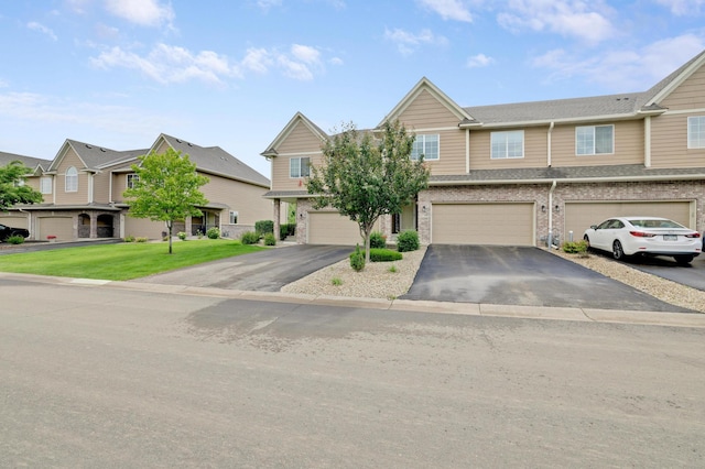 14246 Wilds Dr NW, Prior Lake, MN 55372 - multi unit property featuring driveway, an attached garage, a residential view, brick siding, and a front lawn