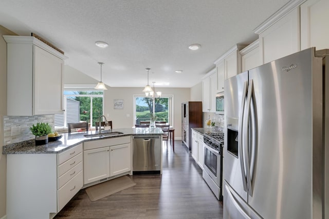 14246 Wilds Dr NW, Prior Lake, MN 55372 - kitchen with appliances with stainless steel finishes, a peninsula, white cabinetry, backsplash, and recessed lighting