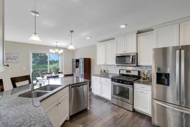 14246 Wilds Dr NW, Prior Lake, MN 55372 - kitchen with appliances with stainless steel finishes, a chandelier, tasteful backsplash, dark wood-style floors, and white cabinetry