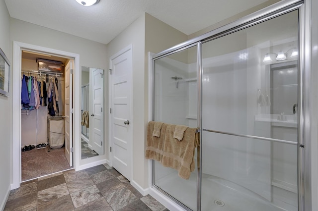 14246 Wilds Dr NW, Prior Lake, MN 55372 - full bathroom with a stall shower, a walk in closet, and stone finish floors