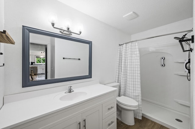 701 Auburn Pl NW, Elk River, MN 55330 - bathroom with vanity, wood finished floors, a shower with shower curtain, and a textured ceiling