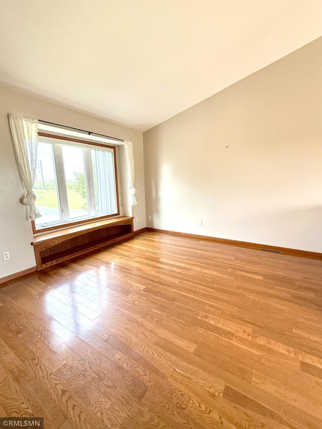 103 Highview Dr, Dassel, MN 55325 - unfurnished room with radiator, light wood-style flooring, and baseboards
