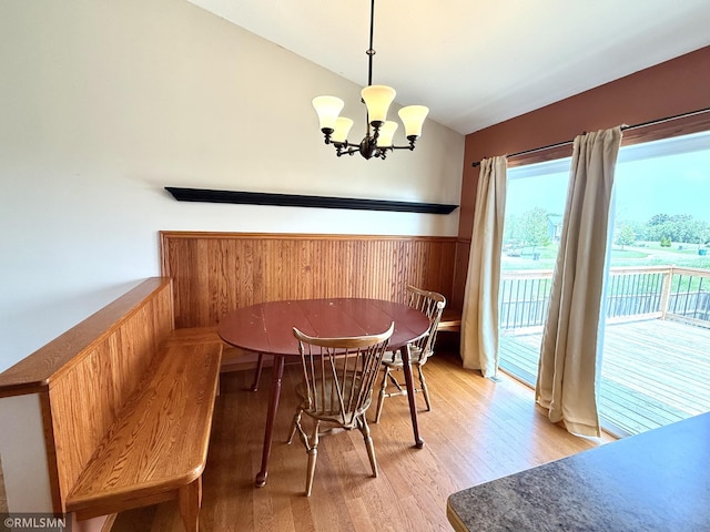 103 Highview Dr, Dassel, MN 55325 - dining room featuring vaulted ceiling, light wood-style flooring, a chandelier, and wainscoting