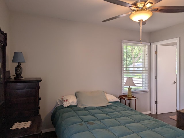 702 Hills Ln, Albert Lea, MN 56007 - bedroom with baseboards, dark wood finished floors, and ceiling fan