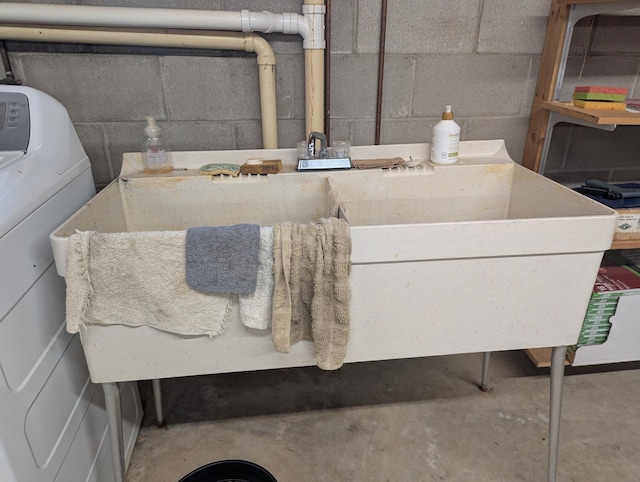 702 Hills Ln, Albert Lea, MN 56007 - detailed view of washer / clothes dryer, concrete floors, and a sink